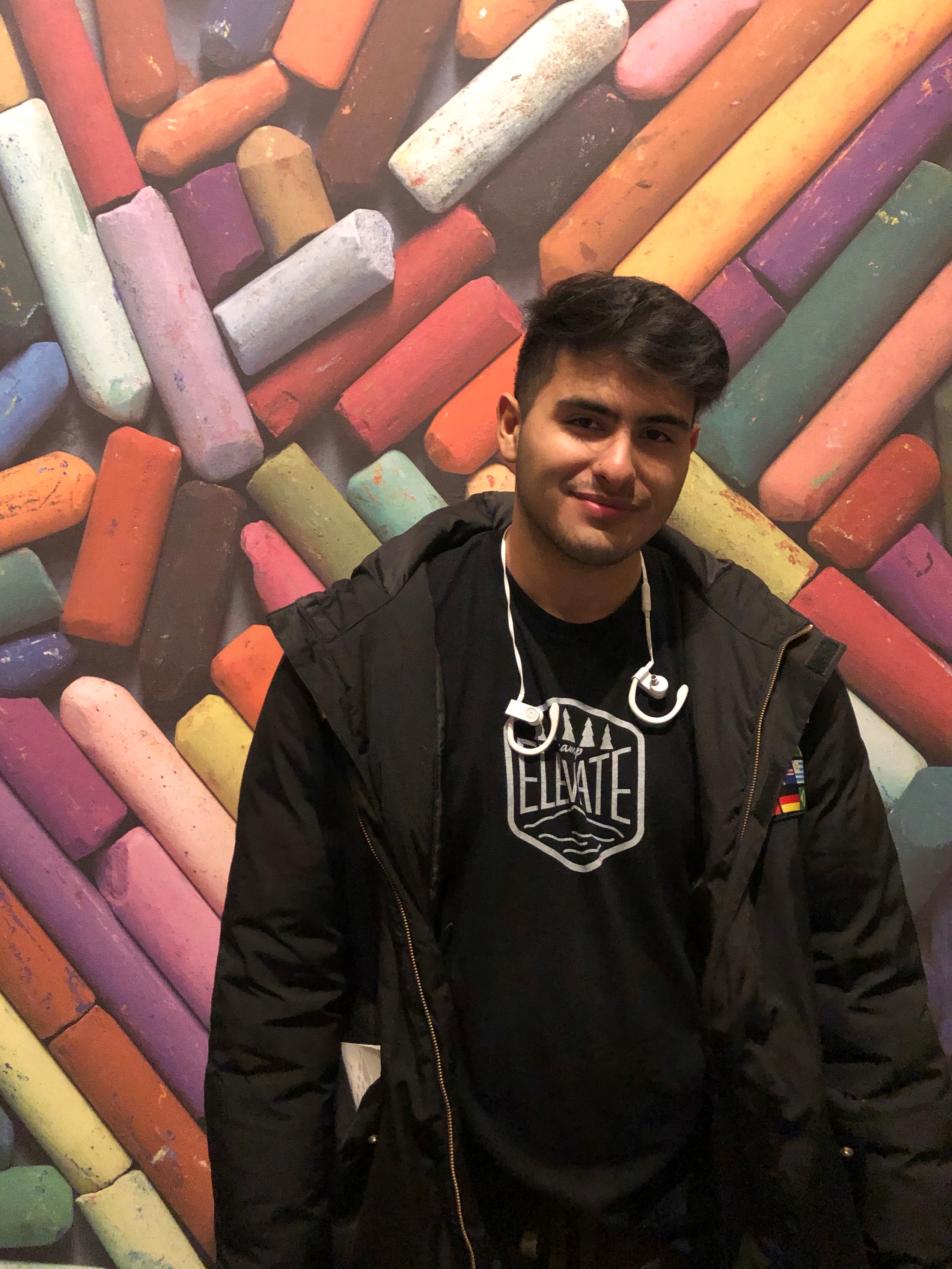 Image of Carlos Martinez in front of a colorful wall
